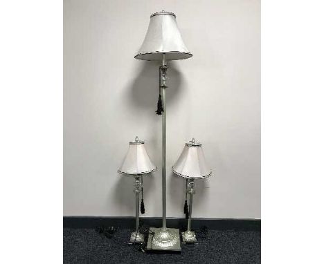 A contemporary floor lamp with shade together with a pair of matching table lamps