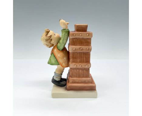 This artist signed figurine depicts a young boy placing coin in chimney like bank. Hand crafted coin bank; hand painted. TMK#