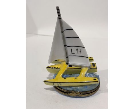 Beautifully hand painted and highly detailed yellow porcelain catamaran with a huge white sail on the water mini box has a gi