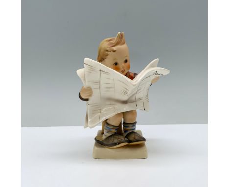 Perched on a stool, a young boy, snug in an orange jacket, slips his feet into his parents oversized slippers, absorbed in re