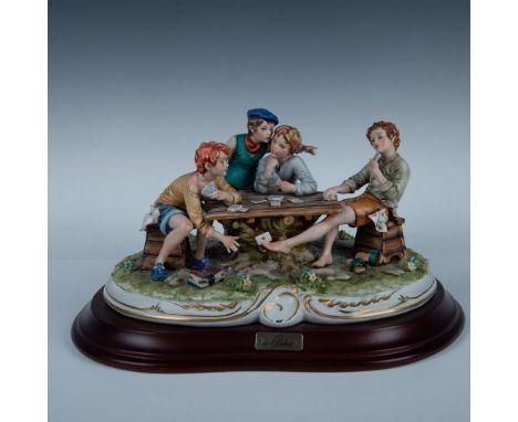 Hand made and hand painted by Germano Cortese. A detailed porcelain scene depicting three boys playing cards, while a fourth 