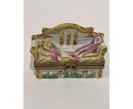 Limited Edition hand painted garden bench mini box. A garden hat and matching scarf lay atop the bench with flowers and green