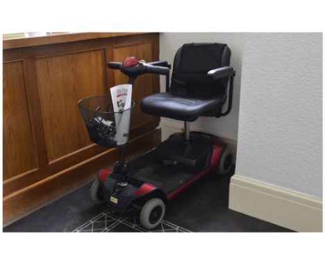Elite Traveller Mobility Scooter together with front carrying basket and instruction manual.