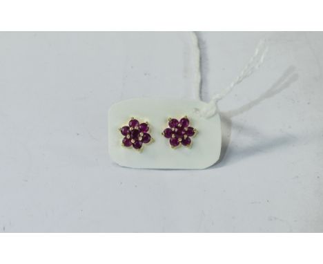 Ruby Floral Cluster Stud Earrings, each earring comprising seven round cut Burmese rubies in the form of a flower, set in 14c