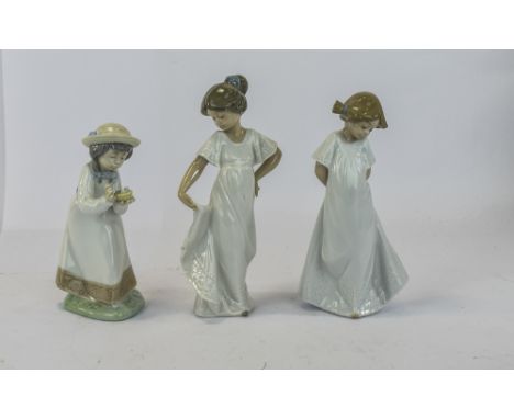 Three Nao by Lladro Figures, all young girls, the tallest 8.5 inches.