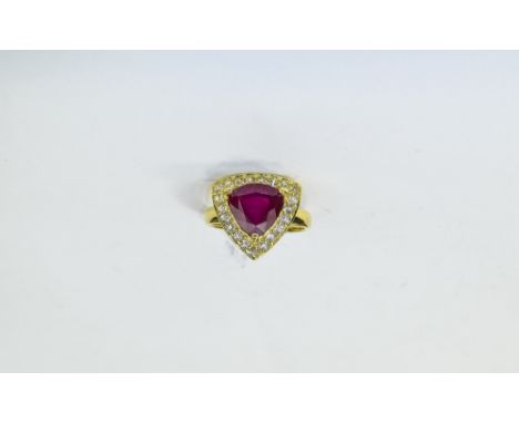 Ruby and White Topaz Trillion Ring, a trillion cut, rich red ruby of 6.3cts, framed with 1ct of round cut white topaz, set in