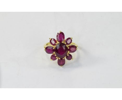 Ruby Cluster Flower Ring, 10.7cts of oval cut rubies comprising eight faceted ovals in two different sizes set as petals arou