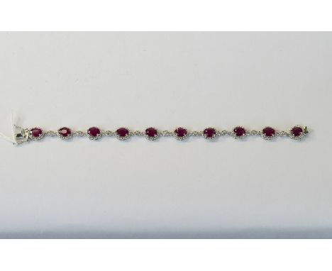 Ruby and White Topaz Bracelet, ten oval cut rubies in milgrain frames of rhodium vermeil and silver, interspaced with small c