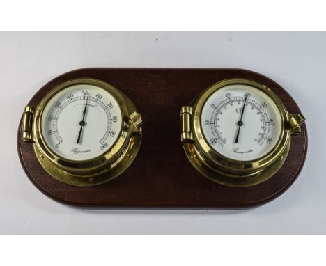 A Good Quality C.F. Wall Mounted Pair of Circular Brass Hygrometer and Thermometer with Locked Glass Panels, Mahogany Backing