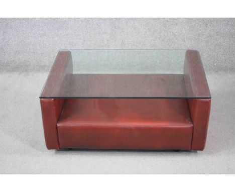A mid century vintage leather faced coffee table with plate glass top. H.36 W.86 D.66 cm. 