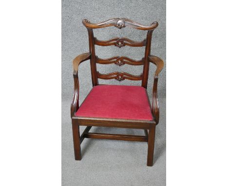A Georgian style mahogany child's armchair with carved ladder back above drop in seat on square stretchered supports. H.66 W.