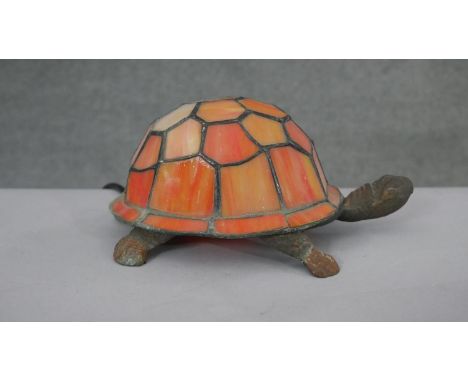 A vintage Tiffany style table lamp in the form of a tortoise with orange stained glass shade, brass body. H.9 W.21 D.15cm 