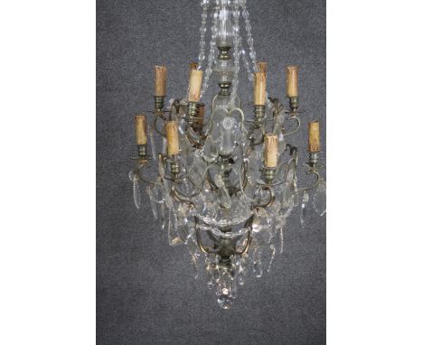 A vintage cut crystal and brass twelve branch chandelier with crystal swags and faceted ball to the bottom. H.120 W.50 cm 