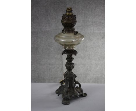 A Victorian cast pewter foliate design oil lamp with cut glass reservoir. Converted for electricity. H.48 W.20 cm. 