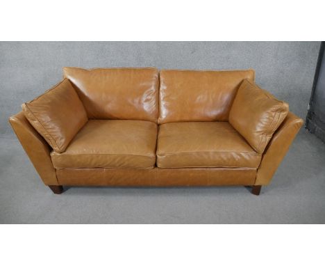 An Art Deco style two seater sofa in light tan leather upholstery. H.84 W.179 D.97cm 