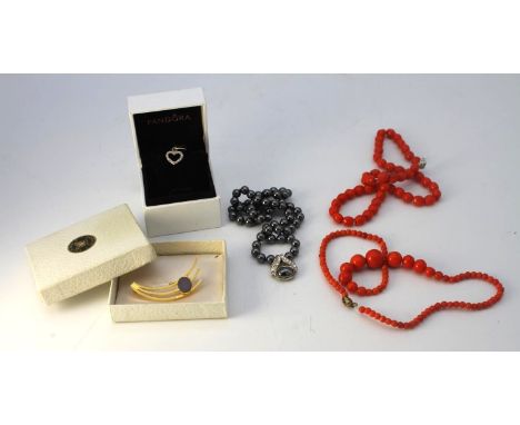 A collection of jewellery. Including a boxed Pandora stone set heart charm, a black opal doublet brooch, a hematite necklace 