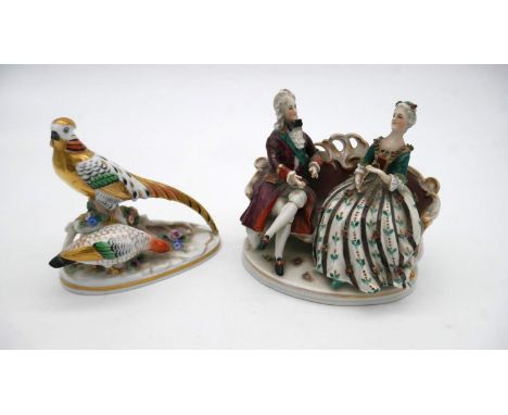 A Crown Staffordshire model of a pheasant, desgned by J. T. Jones along with a Potschapel figure group of a couple on a sofa.