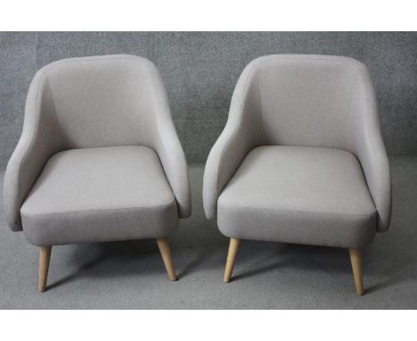 A pair of contemporary vintage style tub armchairs. 