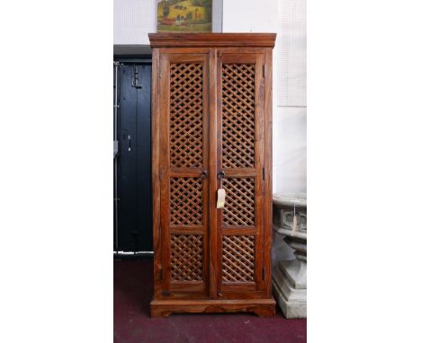 A teak hall cupboard with two doors enclosing shelf space and three drawers, H.180 W.80 D.46cm 