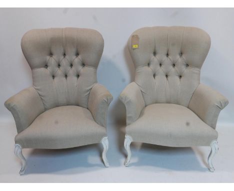 A pair of Victorian style spoon back armchairs with button back upholstery 