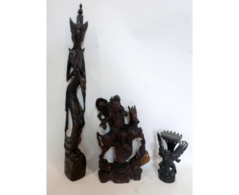 A Chinese hardwood carving of two figures on horse back together with two other carved figures 