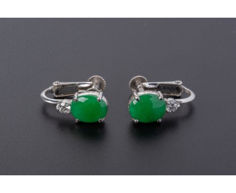 A PAIR OF JADE AND DIAMOND EARRINGS
Set in platinum and 14k white gold, the cabochon jade with a single round brilliant cut d