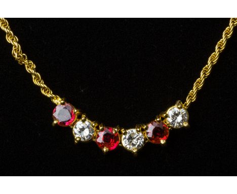 A RUBY AND DIAMOND PENDANT NECKLACE
Set in 20k gold, with round brilliant cut diamonds and rubies on a rope twist chain 
The 