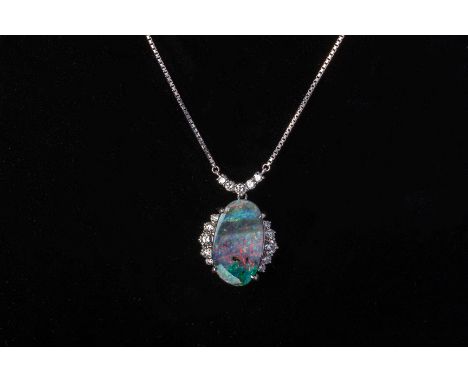 AN OPAL AND DIAMOND PENDANT ON CHAIN
The pendant and chain in platinum, the oval cut boulder opal flanked with three rows of 