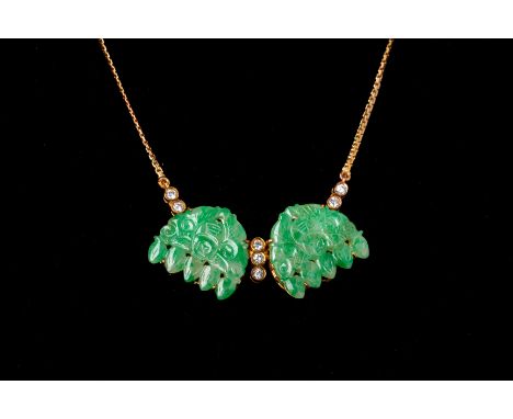 AN ARTICULATED CARVED JADE AND DIAMOND PENDANT NECKLACE
Set in 18k gold, with a pair of carved and pierced jade panels and be