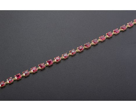 A RUBY BRACELET
Set in 18k gold, with oval cut rubies totalling approximately 6.57cts
18cm long
4.28g
Condition: For a condit