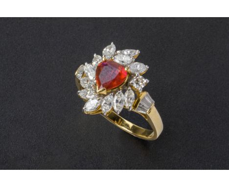 A RUBY AND DIAMOND CLUSTER RING
Set in 18k gold, the central pear shaped ruby with a marquise cut diamond surround and tapere