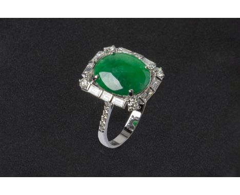 A TYPE A JADEITE AND DIAMOND RING
Set in 18k white gold the cabochon jade with a baguette cut and round brilliant cut diamond