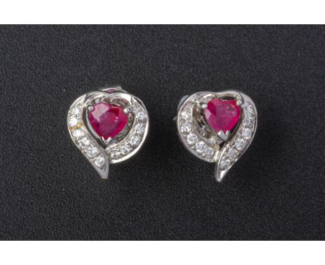 A PAIR OF RUBY AND DIAMOND HEART SHAPED EARRINGS
Set in gold, the heart shaped rubies with a round brilliant cut diamond bord