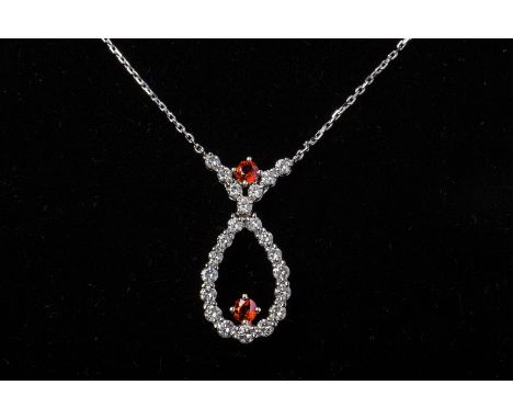 A RUBY AND DIAMOND CROSSOVER PENDANT NECKLACE
The pendant set in platinum in a cross over design with round brilliant cut dia
