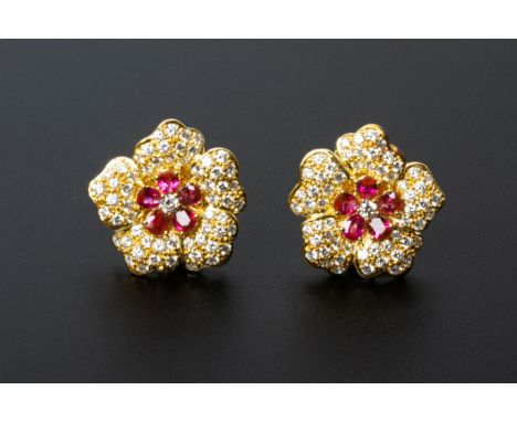 A PAIR OF RUBY AND DIAMOND CLUSTER EARRINGS
Set in 18 gold, the design in the form of a flower with ruby and diamond centre a