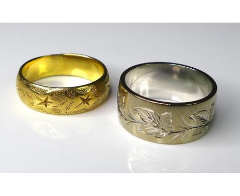 An 18ct white gold band, engraved with leaves, size M, Sheffield 1956, 9.1g, together with an 18ct yellow gold engraved band,