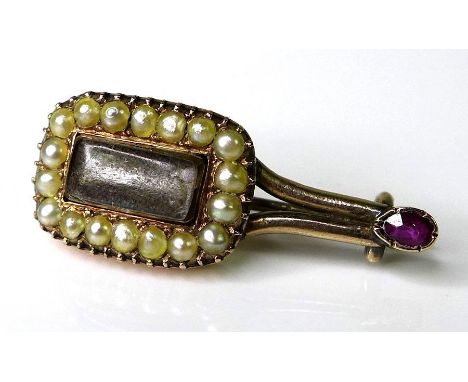 A Victorian mourning brooch in a Halley's Comet design, set with seed pearls and a ruby to the tail, 2.1 by 1.6cm. 