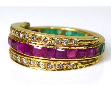 An 18ct gold 'night and day' swivel ring, the central eternity band set to one half with emeralds and to the other half with 