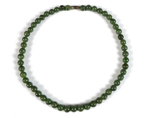 A string of fifty five jade beads, on a yellow metal screw clasp, each approx 8.3mm, 41cm. 