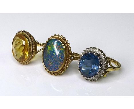 Private Collection-Vintage and Modern design rings: Three 9ct gold rings set with oval stones, the first a black opal in a tw