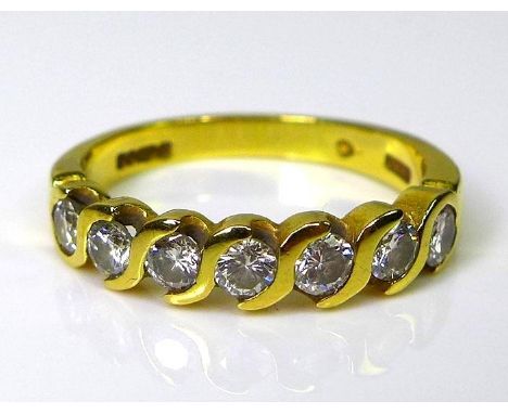 An 18ct gold and diamond half eternity ring in guilloche setting of seven stones, approximately 0.5ct total diamond weight, s