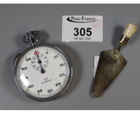 Omega chrome plated stopwatch with Arabic numerals and white face, together with a small, silver bone handled miniature trowe