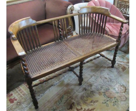 Early 20th century walnut two seater parlor type sofa with cane seat on barley twist supports.(B.P. 21% + VAT) 