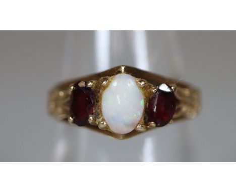 9ct gold opal and garnet ring. Ring size N. Approx weight 3.2 grams. (B.P. 21% + VAT)&nbsp;&nbsp;Appears complete - unfortuna