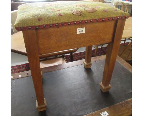 Early 20th century oak piano stool with a tapestry seat above square tapering legs and spade feet.(B.P. 21% + VAT) 