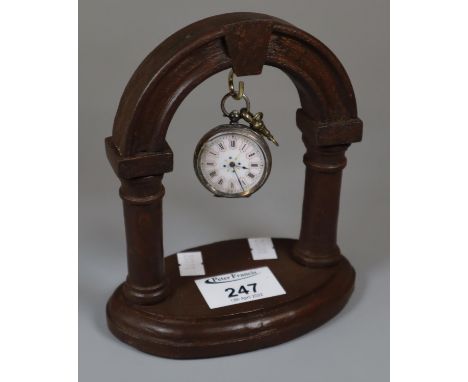 Early 20th century ladies silver and enamel fancy fob watch, together with an architectural design wooden clock holder.(B.P. 