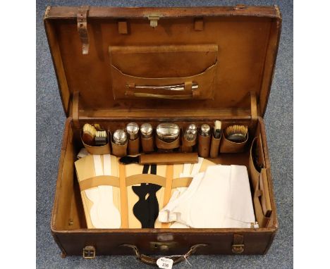 Vintage tan leather cased silver gentleman's vanity set, the interior revealing assorted accessories, dressing table jars, br