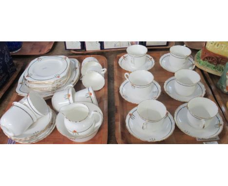 Two trays of Plant Tuscan part teaware decorated with  stylised orange and yellow flowers and a Greek key border black and gu