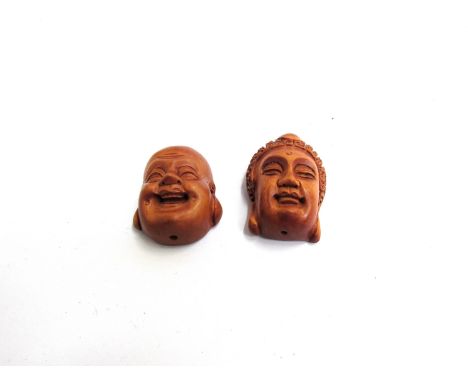 Two carved wood face netsuke 