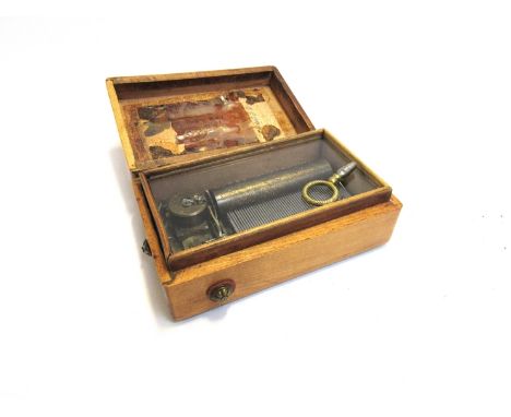 A miniature music box playing four aires, hinge to lid a/f with partial list of songs, 4.5cm x 12.5cm x 8cm 
